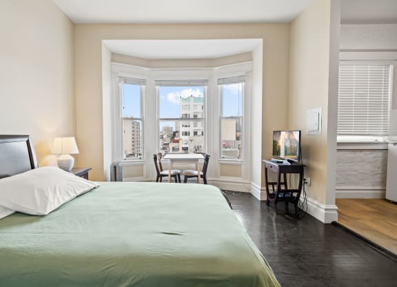 a bedroom with a large bed and a window