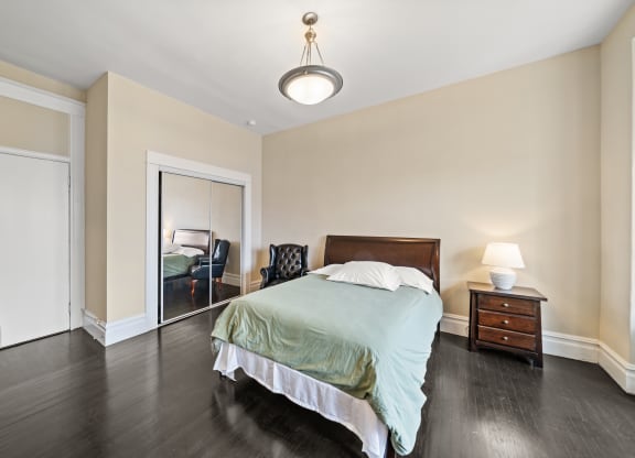 a bedroom with a bed and a closet with a mirror