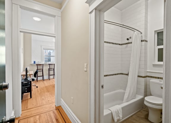 a bathroom with a shower and a toilet and a sink