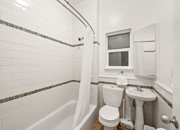 a bathroom with a toilet and a sink and a tub