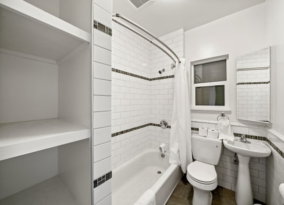 a small bathroom with a toilet sink and tub
