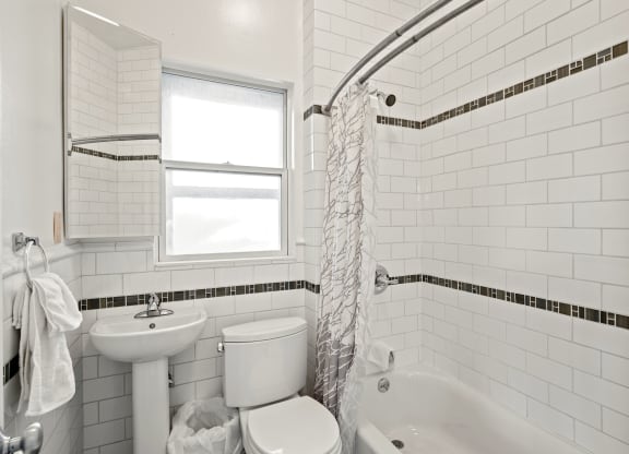 a small white bathroom with a toilet sink and tub