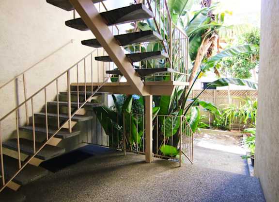 A spiral staircase with a metal railing.