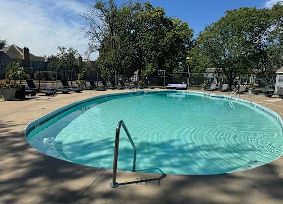 A rectangular pool with a metal ladder on the side.