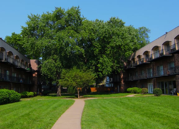 a building with a tree in the middle of a grass field at Waldo Heights, Kansas City, 64131