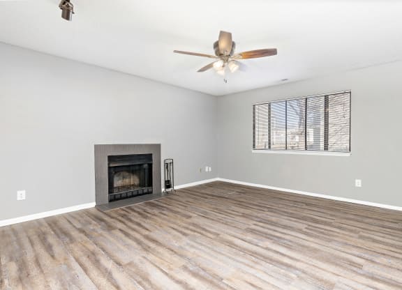Living room with fireplace and wall art at Eddingham in Lawrence, KS
