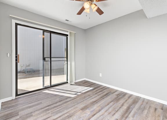 Living room with large patio door at Eddingham in Lawrence, KS