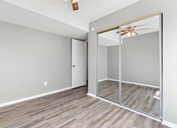 Bedroom with large closet mirror door at Eddingham in Lawrence, KS