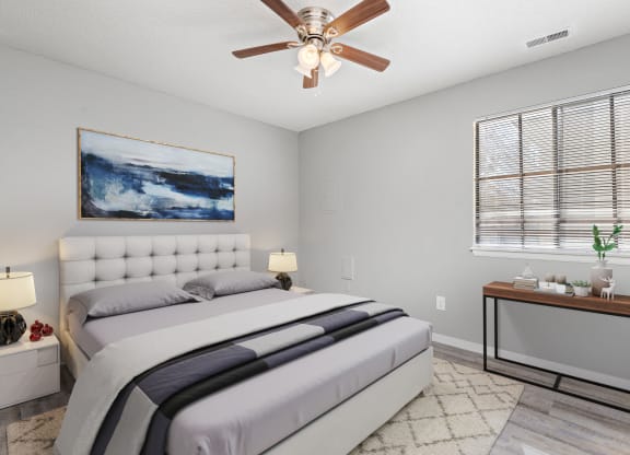 Bedroom with window, bed, and table at Eddingham in Lawrence, KS
