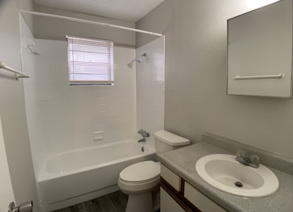 Full bath room with tub and tiling