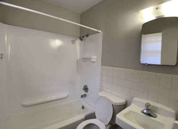 Full bathroom with tub, toilet and vanity
