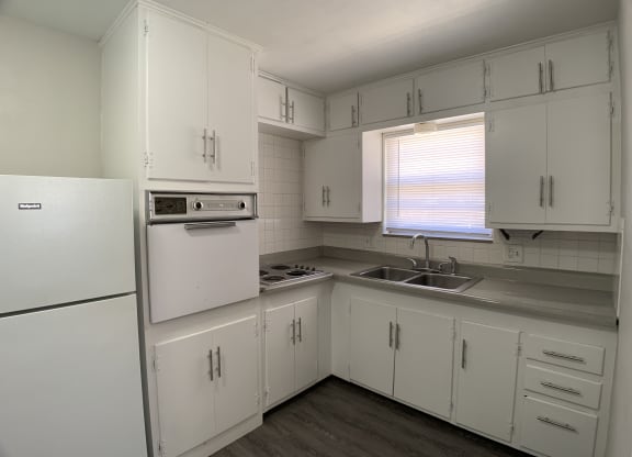 Kitchen with spacious cabinetry, in wall oven and stove top