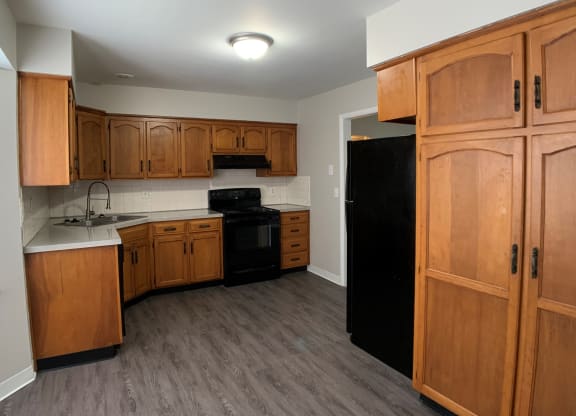 Kitchen with spacious wood cabinetry and black appliances