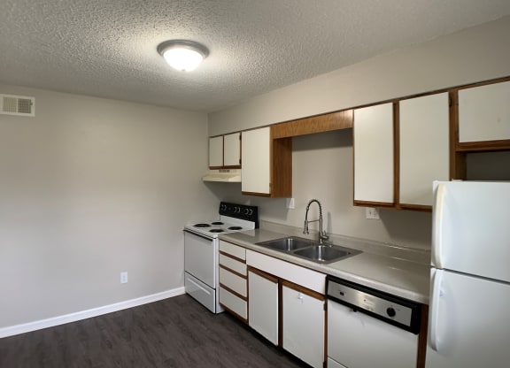 Full kitchen with spacious cabinetry and white appliances