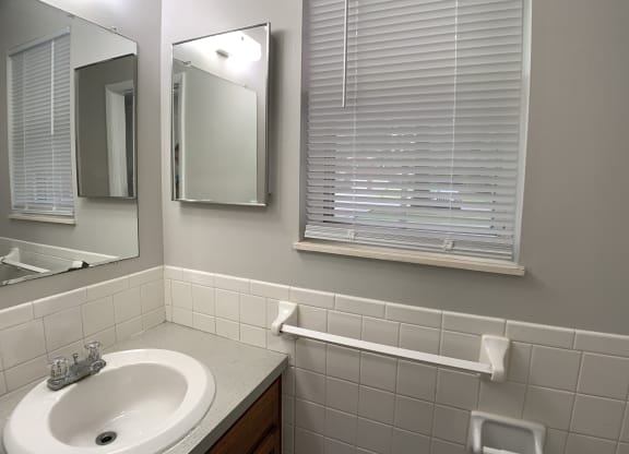 Bathroom with window and sink at Roosevelt in Independence, MO
