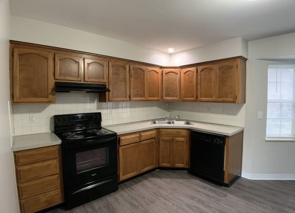 Kitchen with black stove and dishwasher at Roosevelt in Independence, MO