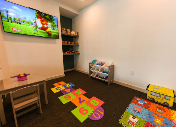 a childs play room with toys and a television at Pinnacle Apartments, Florida, 32256