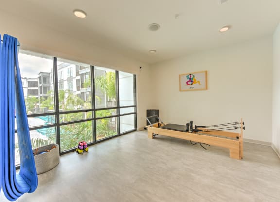 a room with a ping pong table and a large window at Pinnacle Apartments, Jacksonville, 32256