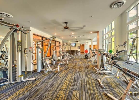 a room filled with lots of different types of exercise equipment  at Fusion, Florida, 32256