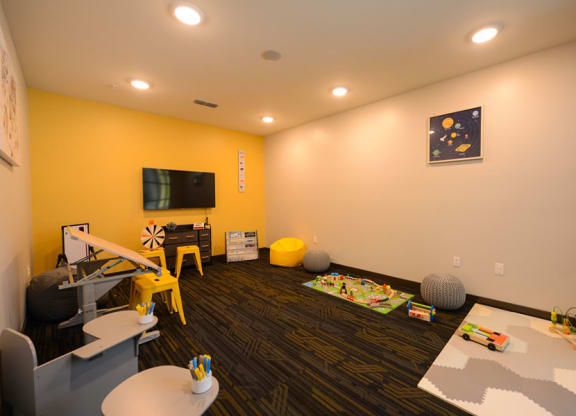 a living room filled with furniture and a flat screen tv  at Fusion, Jacksonville, FL