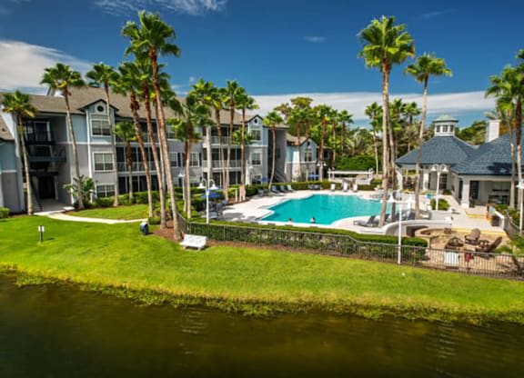 a large swimming pool with palm trees in the background  at Ocean Park, Florida