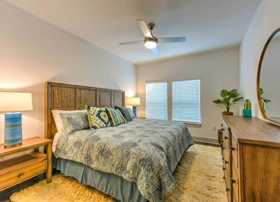 Bedroom with a Bed and Dresser at Fountainhead, Jacksonville, FL, 32258