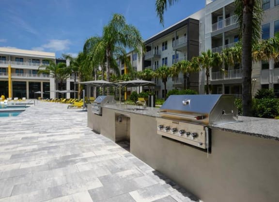 a kitchen with a stove top oven next to a swimming pool  at Fusion, Florida, 32256
