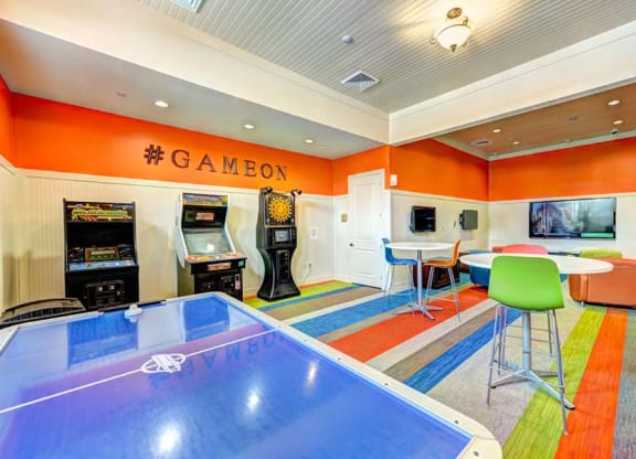 a game room with a ping pong table and arcade games  at Hacienda Club, Jacksonville, 32256