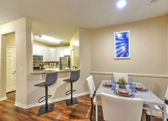a dining room with a table and chairs next to a kitchen  at Ocean Park, Jacksonville Beach