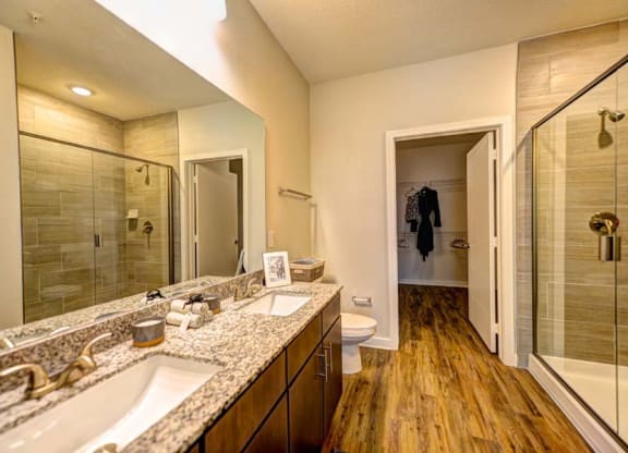 a bathroom with a large mirror and a toilet  at Fusion, Jacksonville, FL, 32256