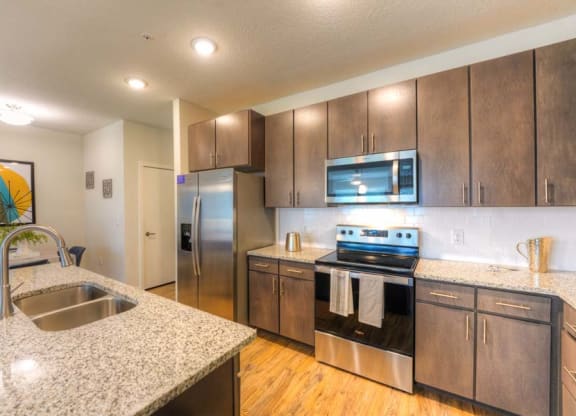 a kitchen with a sink stove and refrigerator  at Fusion, Florida