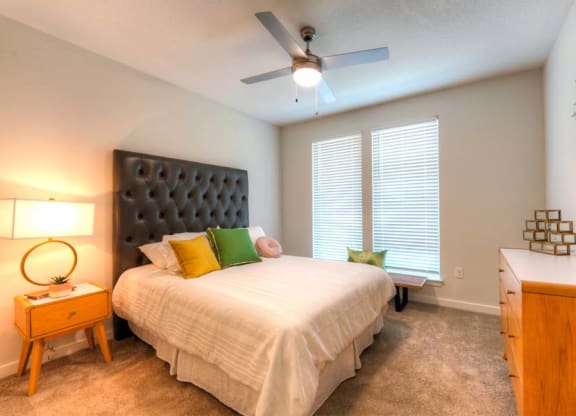 a bedroom with a large bed and a ceiling fan  at Fusion, Jacksonville, 32256