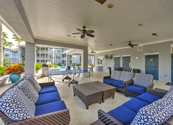 a living room with couches a table and a ping pong table  at Ocean Park, Jacksonville Beach