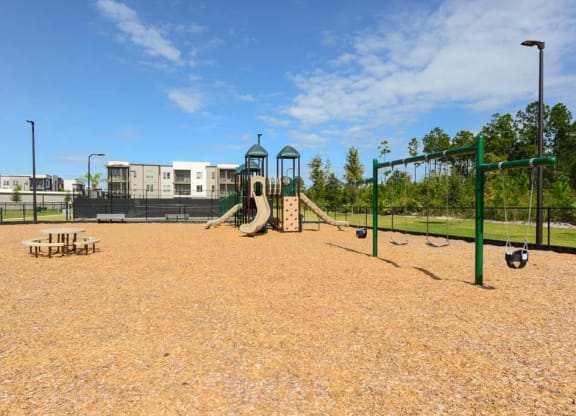 a playground with a slide and monkey bars in front of a building  at Luxor Club, Jacksonville, FL