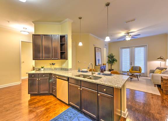 A kitchen with a granite countertop and stainless steel appliances at Alaqua, Florida, 32258