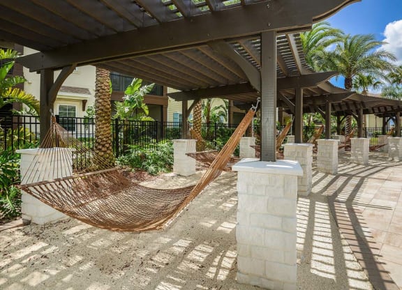 a hammock is set up on a patio in front of a building  at Cabana Club - Galleria Club, Jacksonville, FL