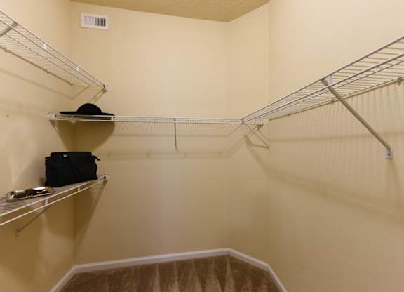 A small closet with a hat on a shelf at Cabana Club - Galleria Club Apartments, Jacksonville, Florida