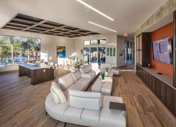 a living room filled with furniture and a large window  at Luxor Club, Jacksonville