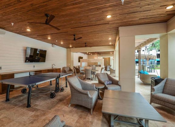 a patio with a ping pong table and chairs  at Palm Bay Club, Jacksonville, Florida