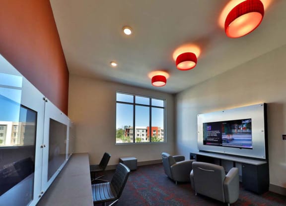 a room with a television and chairs in it  at Luxor Club, Florida