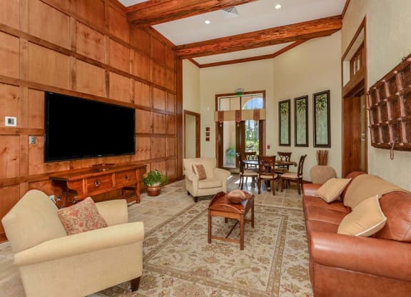 a living room filled with furniture and a flat screen tv  at Hacienda Club, Jacksonville, FL, 32256