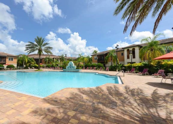 a large swimming pool with a fountain in front of a building  at Hacienda Club, Jacksonville