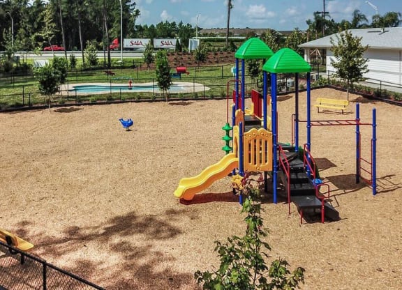 a playground with a slides and a monkey bars  at Palm Bay Club, Florida