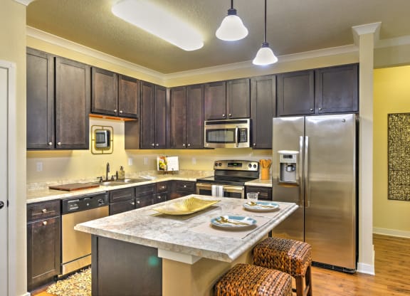 a kitchen with stainless steel appliances and a marble counter top at Hacienda Club, Jacksonville, FL