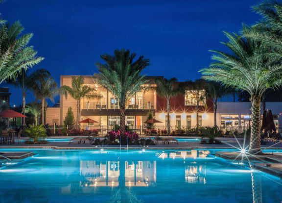 a hotel with a pool in front of it at night  at Luxor Club, Jacksonville, FL, 32258