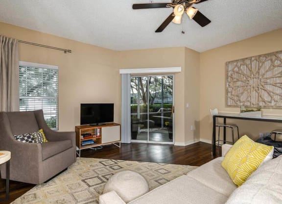 a living room with a couch and a tv  at Ocean Park, Jacksonville Beach