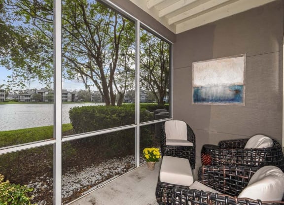 a screened in porch with two chairs and a couch  at Ocean Park, Florida
