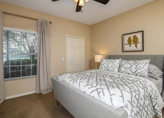 a bedroom with a bed next to a window  at Ocean Park, Florida