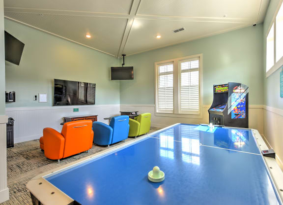 a games room with a ping pong table and a video gameat Palm Bay Club, Jacksonville, Florida