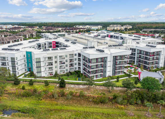A large white building complex with a red roofat Pinnacle Apartments, Jacksonville, FL